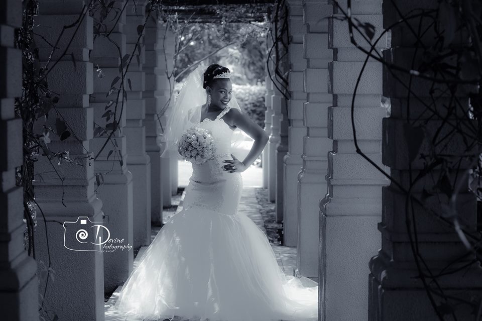 A Uganda bride is a strap trumpet wedding gown captured by Devine Photography
