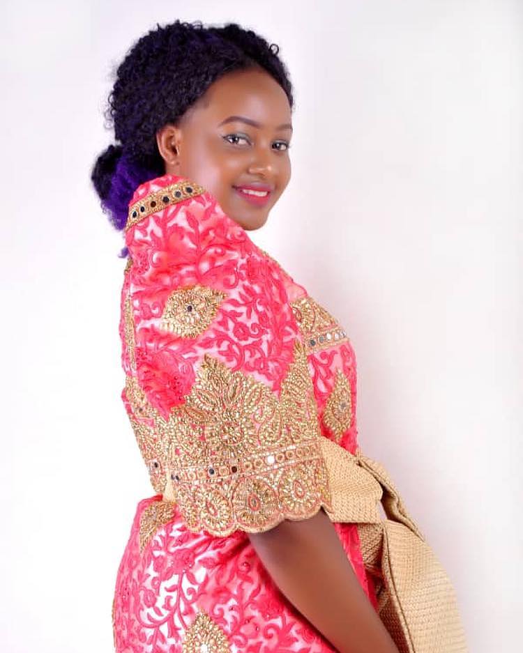 Dhalin Sandra clad in a red and gold gomesi from Kushona Designs