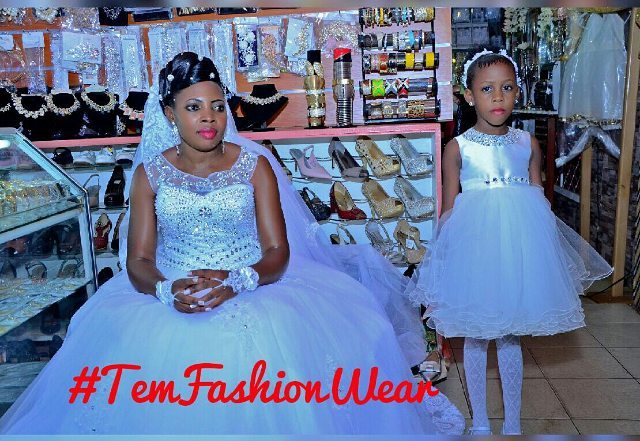 A bride and her flower girl dressed by TEM Fashion WEAR
