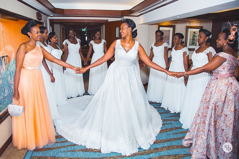 A bride poses for a photo with her entourage at Speke Resort Muyonyo
