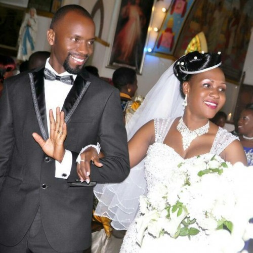 A bride and groom walk in church on their wedding day in Kampala
