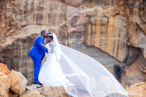 A bride and groom during a wedding photo shoot with Frame Media at the stone querry in Munyonyo