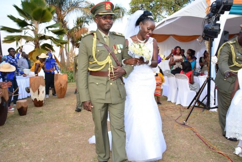 Mr and Mrs Lusiba walk in at their wedding reception amidst performances by Nyange Cultural Performers