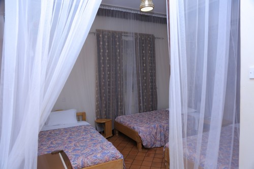 A standard triple room at Adonai Guesthouse in Muyenga