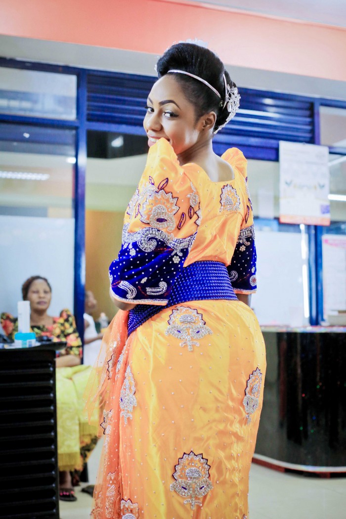 Asha dazzles in a sequined yellow and blue gomesi, photo by Agapix Photography