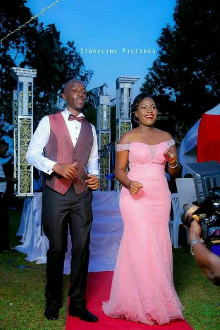 A bride and groom dance at their reception, bride's changing  dressed tailored by Peponi Clothings
