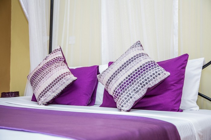 A king size bed inside one of the superior rooms at Adonai Guesthouse in Muyenga, Kampala