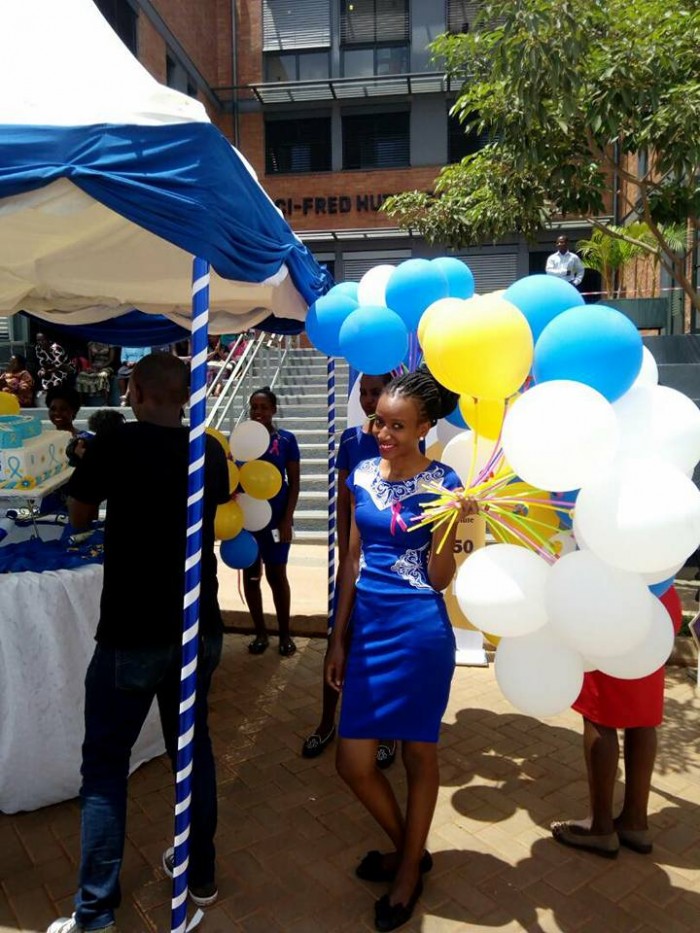 A member of the Dotaz Ushering Services holding balloons at an event in Kampala