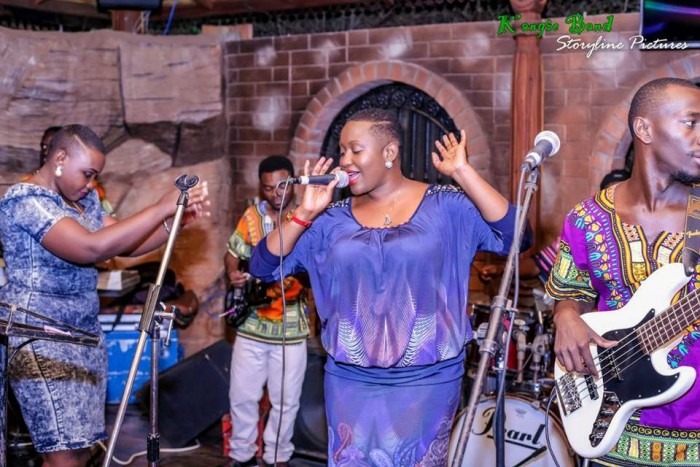 Angela Kalule performing on stage with the K'angie Band