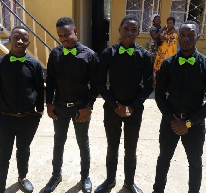 Male ushers clad in black and red bow ties from Sterling Ushers