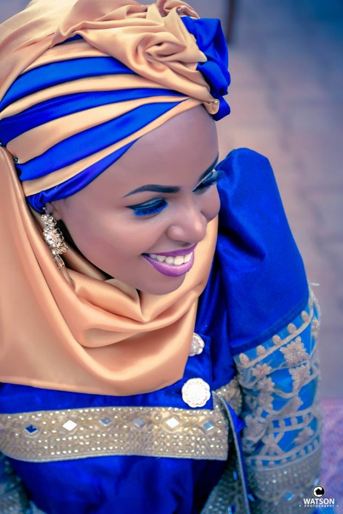 A gorgeous bride in a blue gomesi and a hijab at an introduction