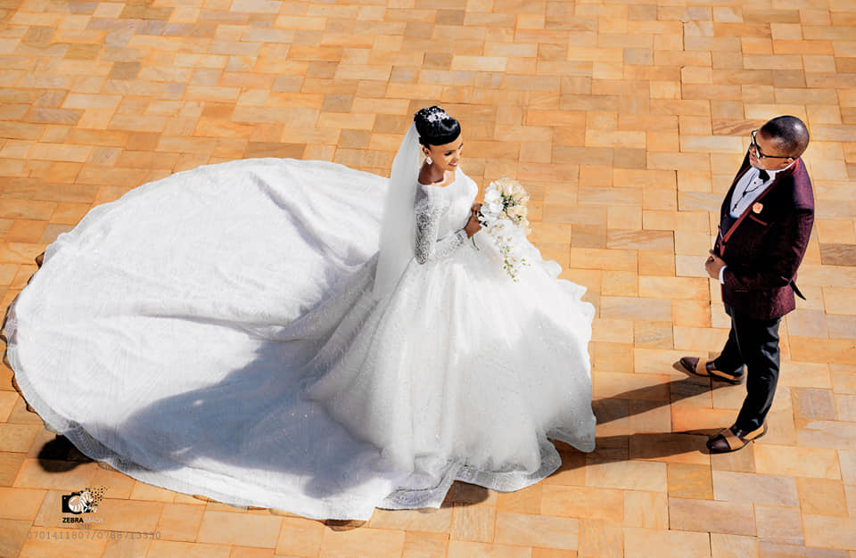 A bride and groom during a wedding photo shoot at Speke Resort Munyonyo
